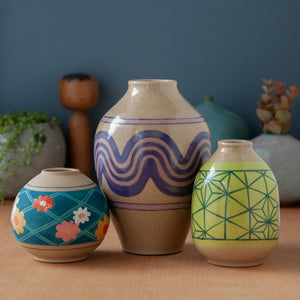 Three vases of varying height with colorful designs.