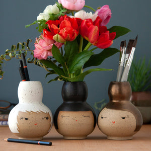 Buddy vases with white, black, and bronze hair