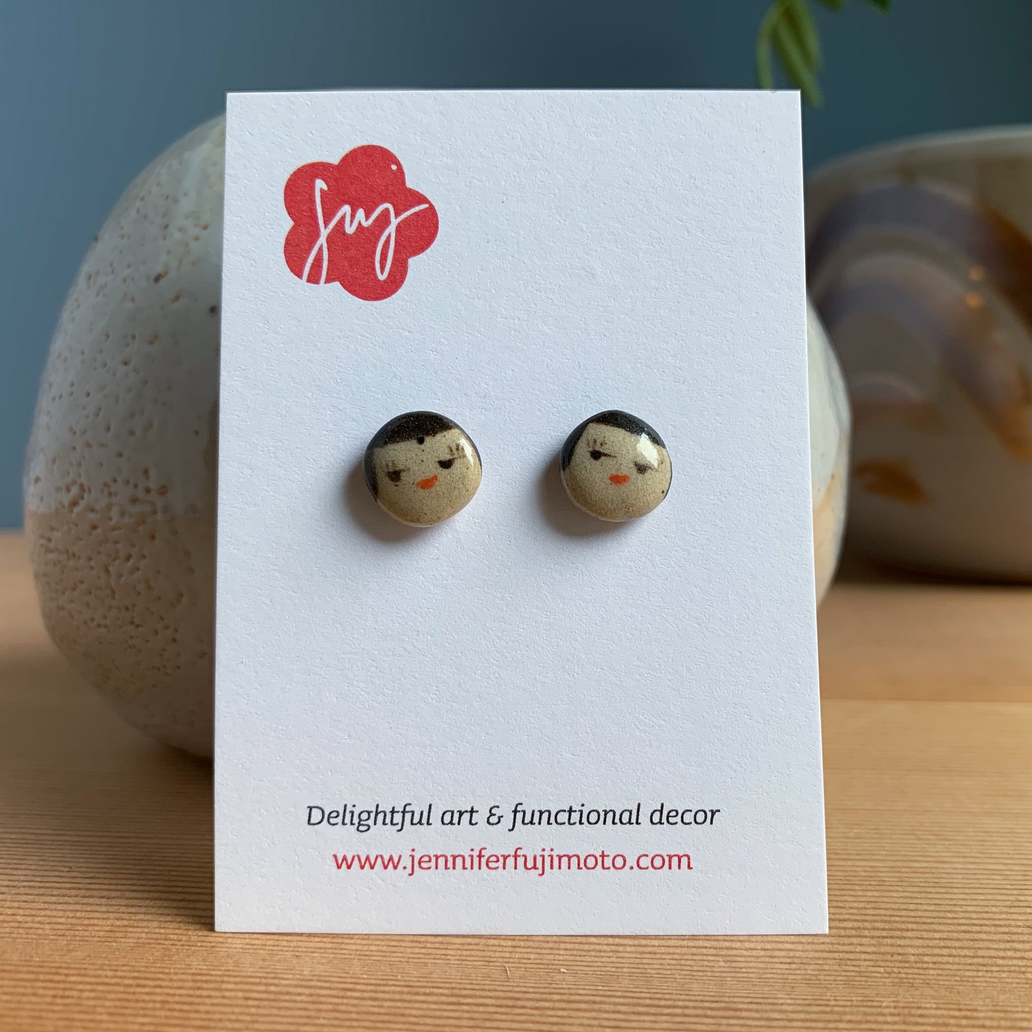 small round face earrings on a backing card