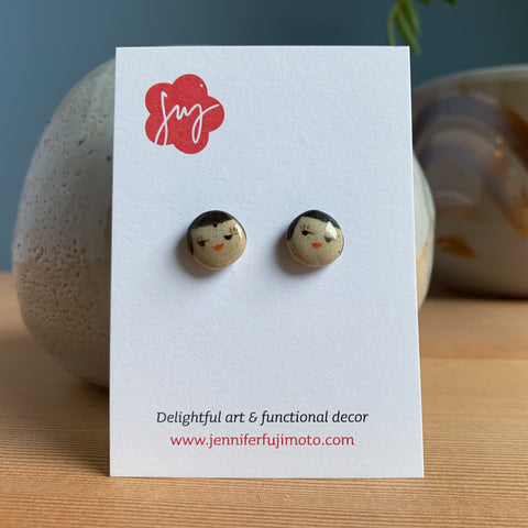 small round face earrings on a backing card
